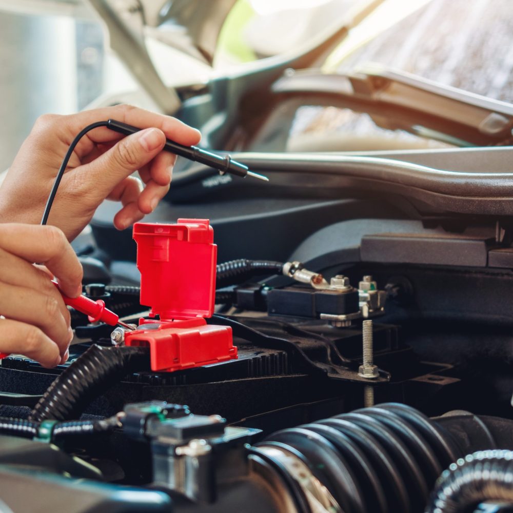 Hands of car mechanic working in auto repair service.